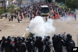 Riot police battle with protesting teachers who were blocking a federal highway in the state of Oaxaca, near the town of Nochixtlan, Mexico, June 19, 2016.