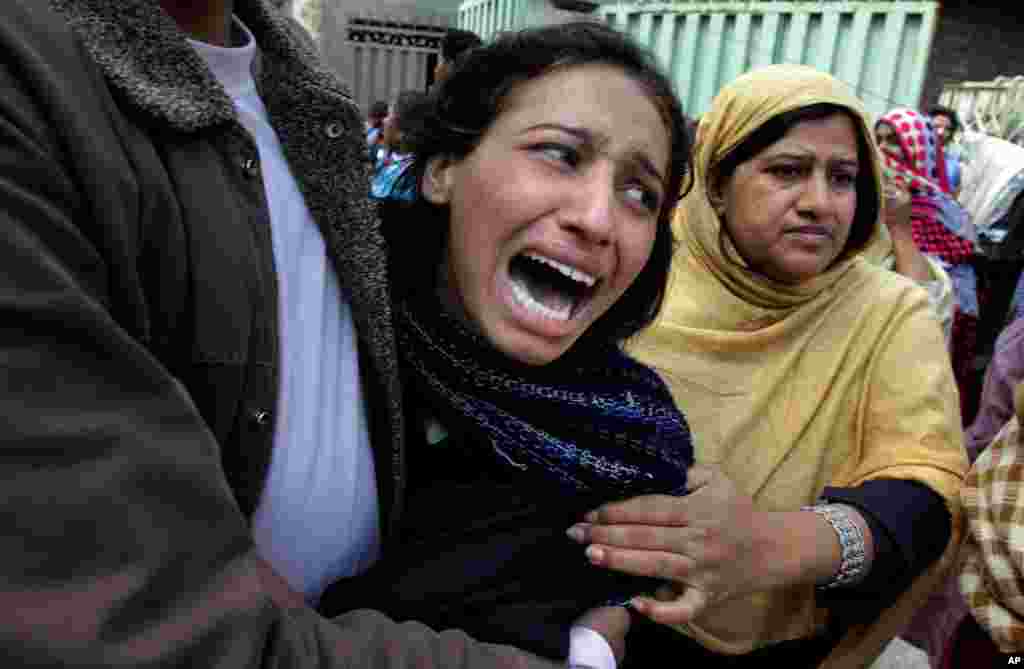 A Pakistani Christian woman mourns over a family member who was killed from a suicide bombing attack near two churches in Lahore.