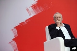 FILE - Jeremy Corbyn, leader of Britain's Labour Party, listens to speakers during the Party of European Socialists Council in Lisbon, Dec. 2, 2017.