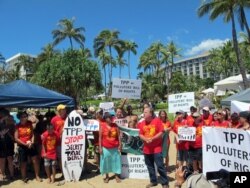 Demonstrators protest outside the Westin Maui resort in Lahaina, Hawaii, where ministers from Pacific Rim nations are gathering to negotiate a new trade pact, July 29, 2015.