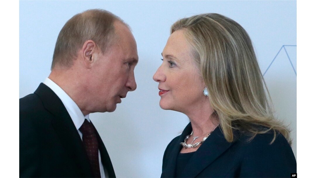 Russian President Vladimir Putin, left, speaks to U.S. Secretary of State Hillary Rodham Clinton on her arrival at the APEC summit in Vladivostok, Russia, Sept. 8, 2012.