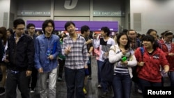 Students leave after a Scholastic Assessment Test (SAT) exam at AsiaWorld-Expo in Hong Kong November 2, 2013. 