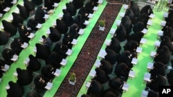 FILE - Iranian women recite verses of the Quran in a mosque at a shrine during Muslim holy fasting month of Ramadan in Shahr-e-Ray, south of Tehran, on June 12, 2016.