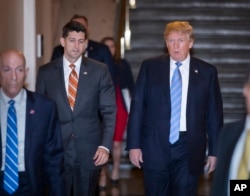 Speaker of the House Paul Ryan, R-Wis., left, walks with President Donald Trump as they head to a meeting of House Republicans to discuss a GOP immigration bill at the Capitol in Washington, June 19, 2018.