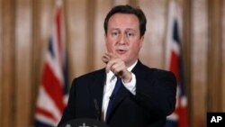 Britain's Prime Minister David Cameron gestures during a press conference in Downing Street in London, where he said aid worker Linda Norgrove, 36, who died in Afghanistan during a rescue attempt, may have been killed by her American rescuers, rather than