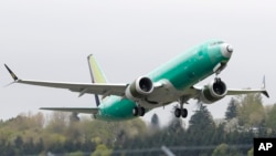 FILE - A Boeing 737 Max 8 airplane being built for India-based Jet Airways takes off on a test flight at Boeing Field in Seattle, April 10, 2019.