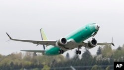 FILE - A Boeing 737 MAX 8 airplane being built for India-based Jet Airways, takes off on a test flight at Boeing Field in Seattle, April 10, 2019. A global team of experts next week will begin reviewing how the Boeing 737 Max's flight control system was