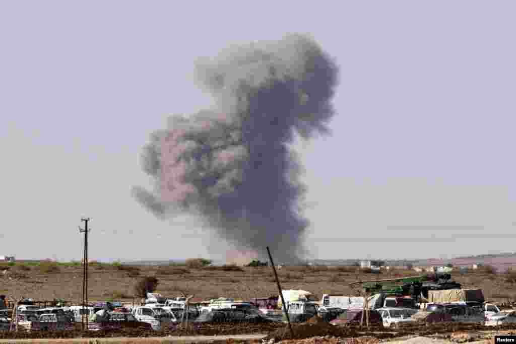 Smoke rises from the Syrian town of Kobani after an air strike, seen from Suruc, Turkey, Oct. 7, 2014.