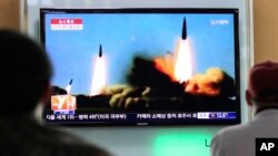 File - People watch a TV news program showing rockets launched by North Korea, at Seoul Railway Station in Seoul, South Korea, Sunday, March 23, 2014. (AP Photo/Ahn Young-joon)