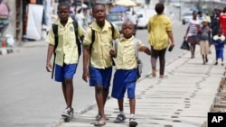 FILE - Schoolchildren walk in the street in Lagos, Nigeria, June 17, 2014. 