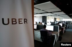FILE - Employees work inside Uber's Center of Excellence office in Cairo, Egypt, Oct. 10, 2017.