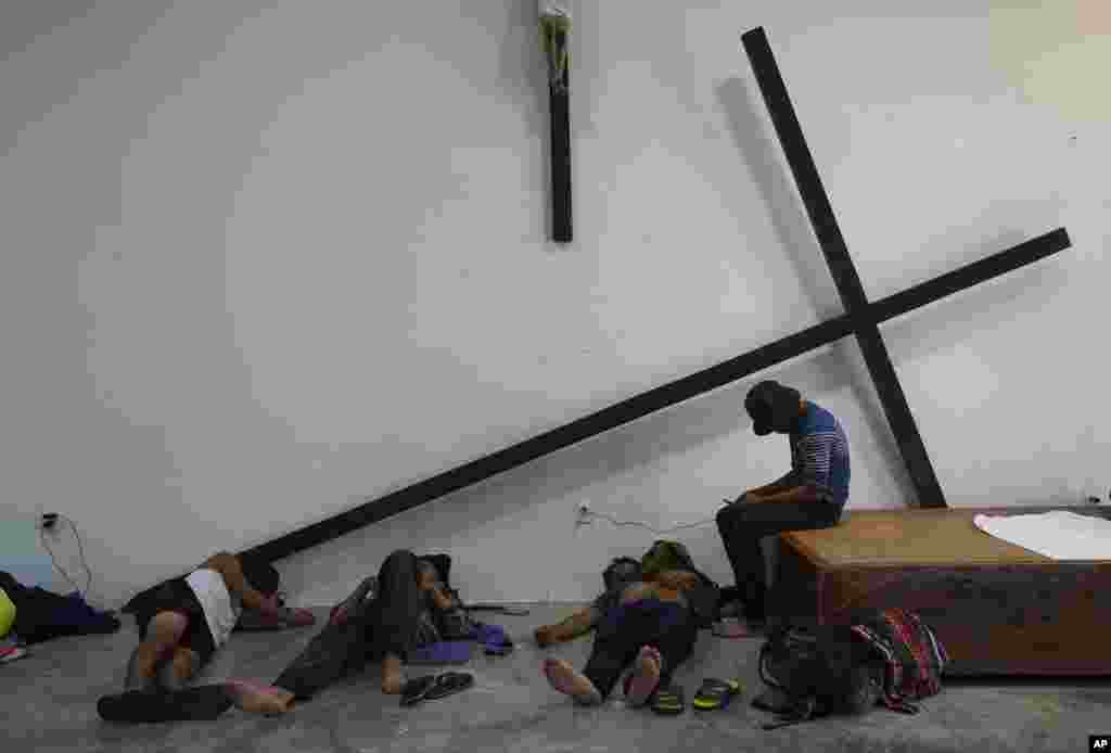 Migrants, who are part of a caravan heading north, stop to rest at the church San Francisco de Asis in Huixtla, Chiapas state, Mexico, Sept. 5, 2021.