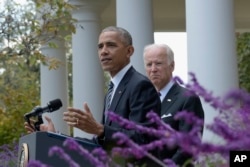President Barack Obama, accompanied by Vice President Joe Biden, speaks about the election results in the Rose Garden at the White House in Washington, Nov. 9, 2016.