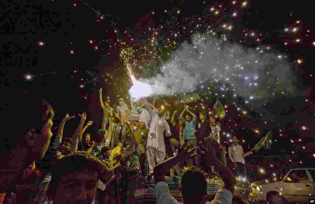 Pakistan Muslim League supporters release fireworks to celebrate after initial results gave their party the lead in parliamentary elections, Lahore, May 12, 2013.