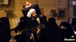 Một người biểu tình cầm bức ảnh của Sheikh Nimr al-Nimr trong 1 cuộc biểu tình tại thị trấn duyên hải Qatif (ảnh tư liệu).