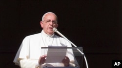 FILE - Pope Francis speaks during the Angelus noon prayer from his studio window overlooking St. Peter's square at the Vatican, Jan. 4, 2015.