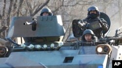 South Korean soldiers ride in an armored vehicle during an annual military exercise near the border with North Korea, Dec. 2, 2016. South Korea and Japan on Friday announced their own new sanctions on North Korea.