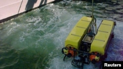 FILE - A Deep Drone underwater surveyor is lowered from the United States Navy's USS Grapple during a "wet check".