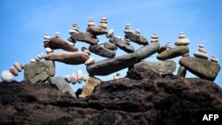 A picture shows a balanced sculpture built during the European Stone Stacking Championships 2019 in Dunbar, Scotland, on April 21, 2019. (Photo by Andy Buchanan / AFP)