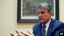 FILE - In this Feb. 1, 2017 file photo, Sen. Joe Manchin, D-W.Va. is interviewed by The Associated Press in his office in Washington.