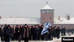 Members of a Knesset delegation walk in front of former Auschwitz-Birkenau concentration camp during ceremonies to mark the 69th anniversary of the liberation and commemorate the victims of the Holocaust in Birkenau, Germany, Jan. 27, 2014. 