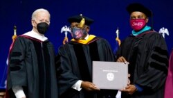 Rep. Jim Clyburn, D-S.C., center, holds a diploma with South Carolina State University Interim President Alexander Conyers as President Joe Biden stands at left during South Carolina State University's 2021 fall commencement ceremony in Orangeburg, S.C.,