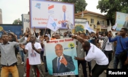 FILE - Supporters of Congolese presidential candidate Martin Fayulu celebrate after the opposition coalition chosen him to be the candidate in a December presidential election, in Kinshasa, Nov. 12, 2018.