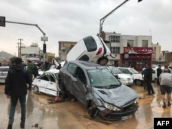 An image made available by Iran's Mehr news agency on March 25, 2019, shows flood-strewn cars piled up in a street in the southern city of Shiraz.