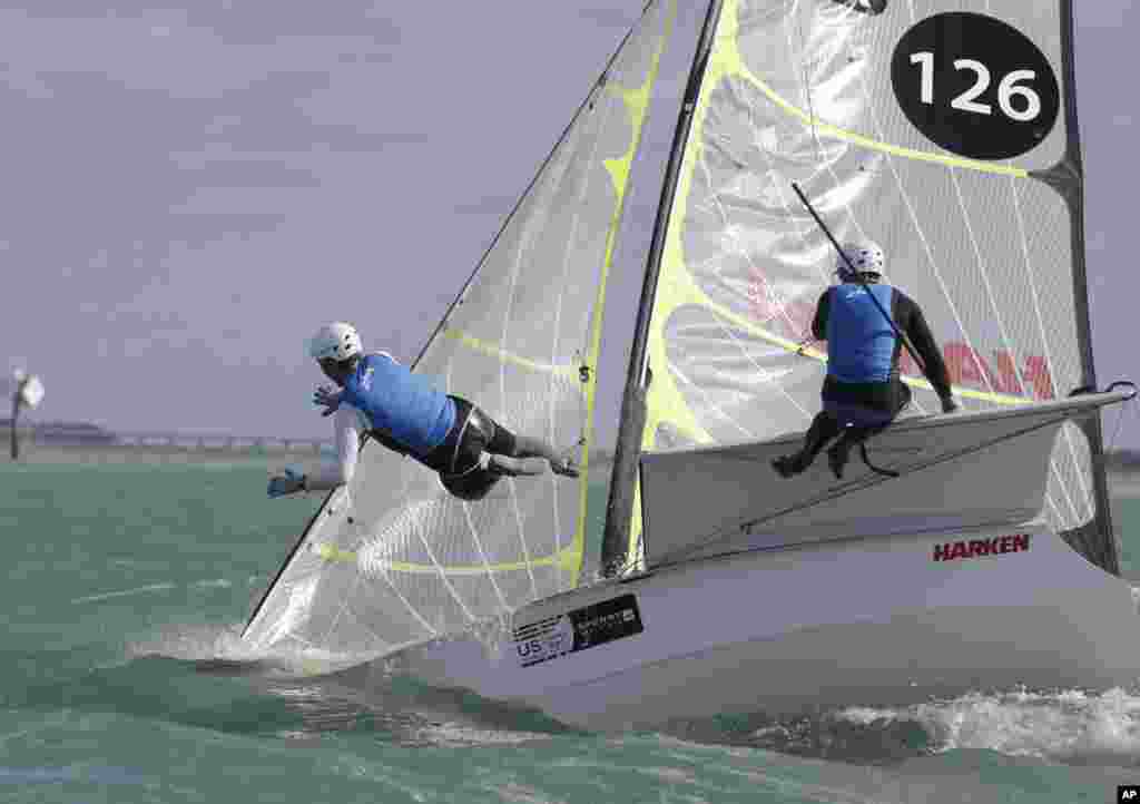 A competitor with the U.S. sailing team of Zack Downing and Riley Gibbs, in the 49er class, falls into the water during the ISAF Sailing World Cup Miami on Biscayne Bay in Miami, Florida, Jan. 26, 2015.