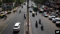 Few vehicles are seen plying on the otherwise severely busy Mehrauli Badarpur road during rush hour in New Delhi, India, Friday, April 15, 2016.