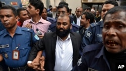 Security personnel escort Delwar Hossain, one of two owners of a Bangladesh garment factory where more than 110 workers died in a fire two years ago, to court in Dhaka, Bangladesh, Feb. 9, 2014.