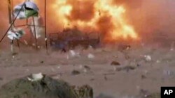 A car bomb at the moment of explosion; one in a series of bombs that exploded, April 25, 2014 at a campaign rally for a Shi'ite group in Baghdad, Iraq.