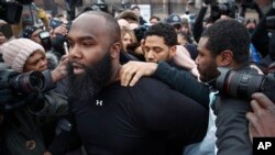 "Empire" actor Jussie Smollett, rear center, leaves Cook County jail following his release in Chicago, Feb. 21, 2019.