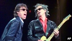 FILE - Mick Jagger, left, and Keith Richards perform "Jumping Jack Flash" during the Rolling Stones' No Security Tour performance at the Fleet Center in Boston on March 22, 1999. 
