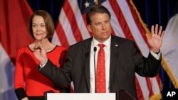 FILE - North Carolina Governor Pat McCrory speaks to supporters as his wife, Ann McCrory, listens at an election rally in Raleigh, N.C., Nov. 9, 2016.