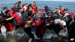 Refugees arrive on a dinghy after crossing from Turkey to Lesbos island, Greece, Sept. 8, 2015.