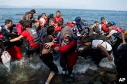 Refugees arrive on a dinghy after crossing from Turkey to Lesbos island, Greece, Sept. 8, 2015.
