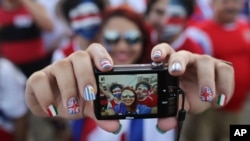 Costa Rica soccer fans pose for a selfie before watching their team's World Cup round of 16 match against Greece on a live telecast inside the FIFA Fan Fest area on Copacabana beach in Rio de Janeiro, Brazil, June 29, 2014.