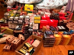 This photo provided by the Los Angeles Police Department shows gun parts and ammunition, part of a large cache of weapons seized at a home in the affluent Holmby Hills area of Los Angeles, May 8, 2019.