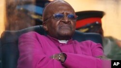 FILE - In this Dec. 10, 2013 photo, Retired Anglican Archbishop Desmond Tutu waits to speak during the memorial service for former South African president Nelson Mandela at the FNB Stadium in Soweto near Johannesburg.