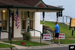 A voter enters City Hall in Lecompton, Kansas, to vote in the state's primary election, Aug. 2, 2016.
