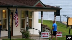 FILE - A voter enters City Hall in Lecompton, Kansas, to vote in the state's primary election, Aug. 2, 2016.