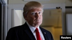 U.S. President Donald Trump pauses as he talks to journalists who are members of the White House travel pool on board Air Force One during his flight to Palm Beach, Florida, Feb. 3, 2017.