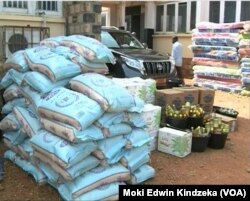 Piles of food aid, left, and mattresses, right, are distributed to internally displaced people in the English-speaking town of Bamenda, April 3, 2019.