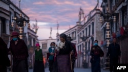 shows pilgrims walking and praying near the Jokhang Temple