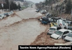 Vehicles are stacked one against another after a flash flooding In Shiraz, Iran, March 25, 2019.