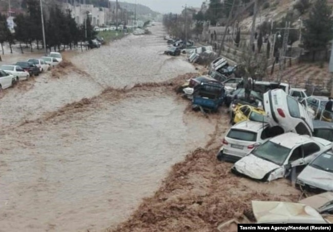 Vehicles are stacked one against another after a flash flooding In Shiraz, Iran, March 25, 2019.