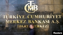 FILE - A man passes by Turkey's central bank headquarters in Ankara, Turkey, April 19, 2015.