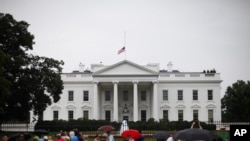 The American flag is seen at half-staff over the White House in Washington 