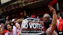 An anti-government supporter wearing a cap with a "No vote" sticker attends a march through China Town in Bangkok, Feb. 1, 2014.